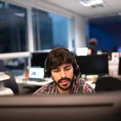 Support Agent Wearing a Headset to Chat With a Customer Over The Phone